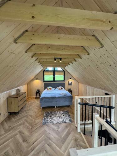 a bedroom in a wooden cabin with a bed in it at Jeleśniczówka in Jeleśnia