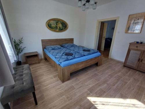 a bedroom with a bed with a blue comforter at Villa Oliva in Český Krumlov