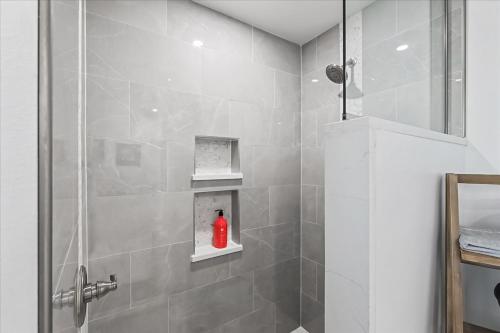 a bathroom with a shower with a red bottle on a shelf at Staying in Yakama Valley in Yakima