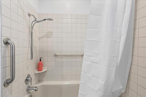 a bathroom with a shower with a white tiled wall at Staying in Yakama Valley in Yakima