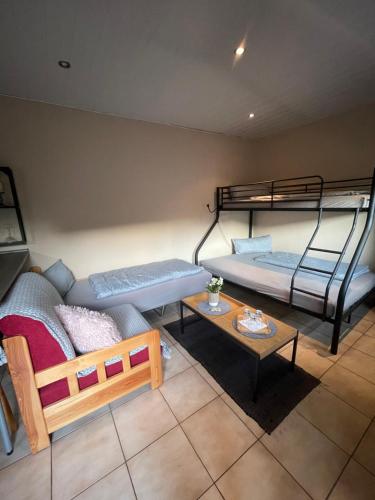 a room with two bunk beds and a table at Eleni in Bad Bramstedt