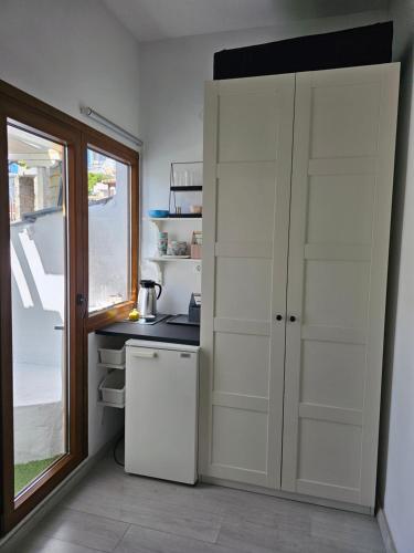 a kitchen with a white refrigerator and a window at Bunkbedroom in Patitiri