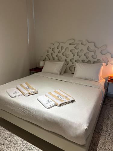 a bed with two towels on top of it at G cribs cozy 1bd apartment in El Gouna