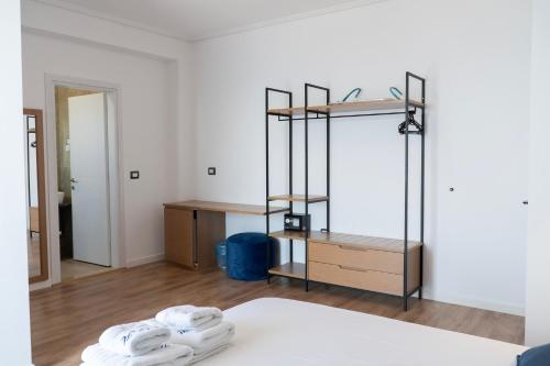 a room with a bed with towels on it at Hilltop Heaven Hotel in Sarandë
