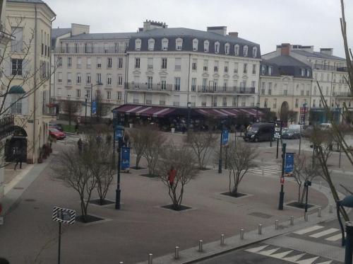 a city street with trees in front of a building at Disneyland Paris perfect for 5 ! in Serris