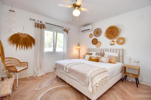a bedroom with a bed and a ceiling fan at Casa la Flor, villa with seaview in region Malaga in Sayalonga