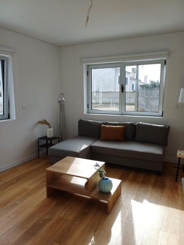 a living room with a couch and a coffee table at Azure Escape Azores in Arrifes
