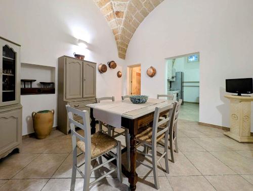 a kitchen with a table and chairs and a tv at Antica Dimora Via Roma in Maglie