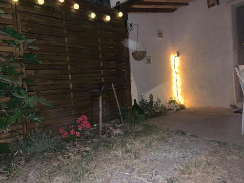 a room with a wooden wall with lights on it at Le gîte des Oliviers in Forcalquier