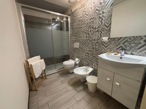 a bathroom with a sink and a toilet and a shower at Agata dreams apartment in Catania