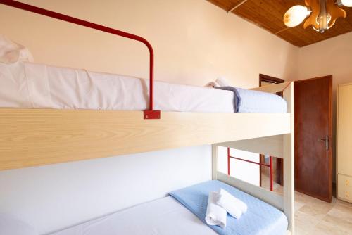 a bedroom with two bunk beds in a room at Dimora PietrAnna - Paradiso in Sardegna in Li Valcaggi