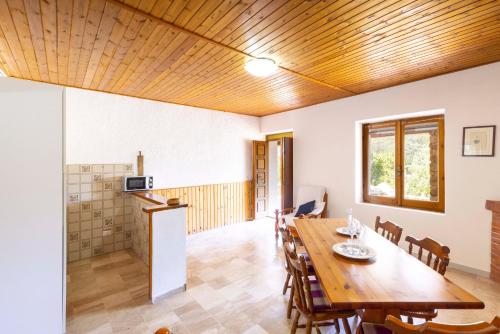 a dining room with a wooden table and chairs at Dimora PietrAnna - Paradiso in Sardegna in Li Valcaggi
