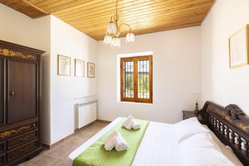 a bedroom with a large bed and a wooden ceiling at Dimora PietrAnna - Paradiso in Sardegna in Li Valcaggi