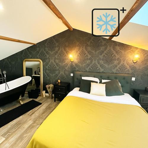 - une chambre avec un lit jaune et une baignoire dans l'établissement L'échoppe Bergeracoise, Salle de jeux, Climatisation et terrasse, à Bergerac