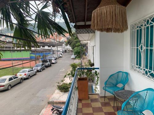 a balcony with a blue chair and a view of a street at Lucca Hostel Medellín in Medellín