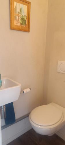 a bathroom with a white toilet and a sink at T2 2-4 pers-Balcon-Magnifique Vue Mer et Baie des Sables d'Olonne in Les Sables-dʼOlonne
