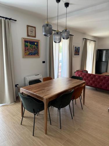 a dining room table and chairs in a living room at Villa Maluso in Budva