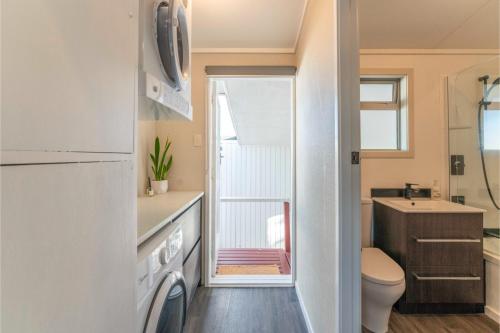 a small bathroom with a toilet and a sink at The Cozy Corner - Taupo Holiday Home in Taupo