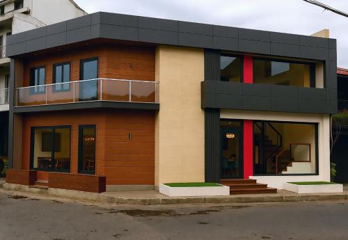 a brown and black house on a street at BuenaSentro Hostel in Manila