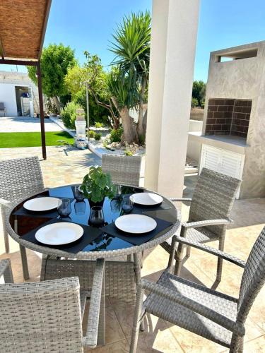 a table and chairs on a patio at Premium 2025 Housing with BBQ in Paralimni