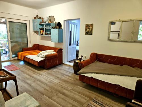 a living room with a couch and a bed at Green Haven Retreat - Nature's peace just for you in Rakovac