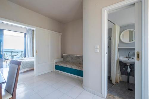 a bathroom with a bench and a sink and a mirror at ELIXIA in Tolo