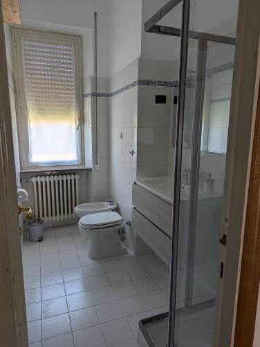 a bathroom with a toilet and a sink and a shower at Il Pincio Apartment, Cagli in Cagli