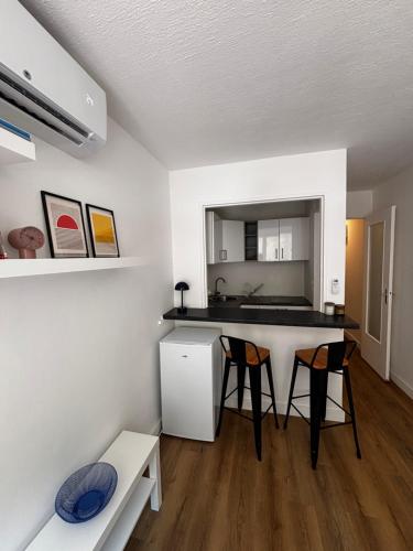 - une cuisine avec un comptoir et des chaises dans la chambre dans l'établissement Nice appartement for 2 adults with air-conditioning, à Nice