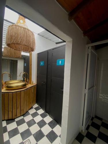 a bathroom with a sink and a mirror at Lucca Hostel Medellín in Medellín