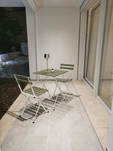a glass table and two chairs on a patio at La Bianca Dimora in Sulmona