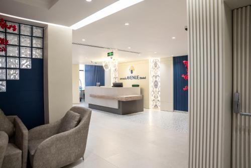 a lobby with two chairs and a desk at Armada Avenue Hotel Amman in Amman
