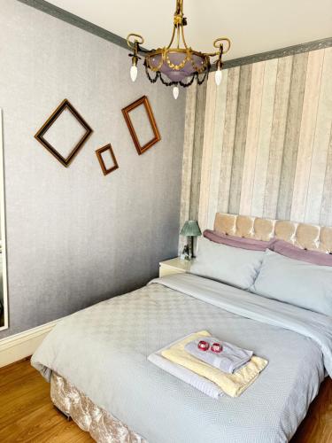 a bedroom with a bed with a towel on it at Upton Country Park Guest House in Northampton