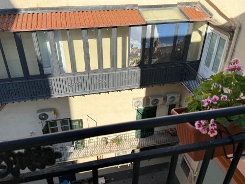 a balcony of a building with balconies and flowers at HrD Luxury Rooms in Palermo