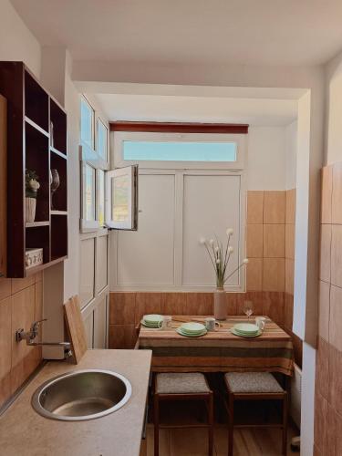 a kitchen with a sink and a table with chairs at Porta Mare Apartment in Bar