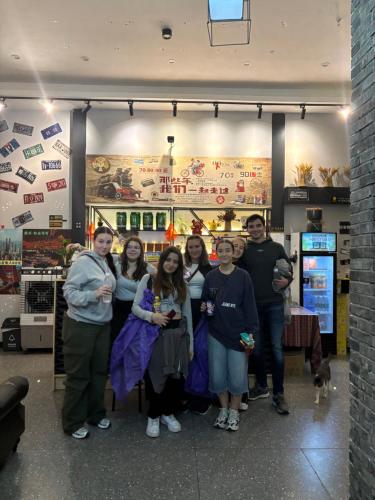 a group of people posing for a picture in a store at Riverside International Youth Hostel阅江老院青年旅舍 in Chongqing