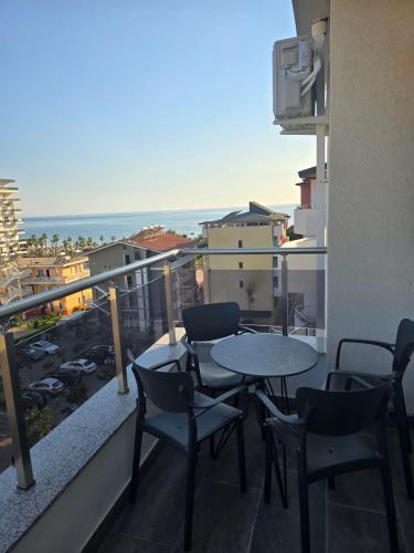 a balcony with a table and chairs and the ocean at Hotel Ersi in Shëngjin