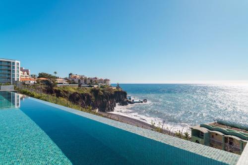 a swimming pool with a view of the ocean at GuestReady - Soothing escape in Funchal in Panasqueira