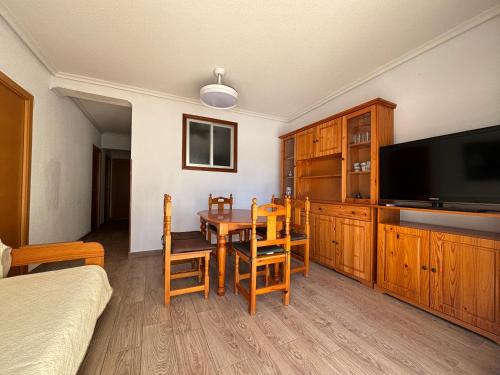 a bedroom with a dining room table and a television at Casablanca in Miramar
