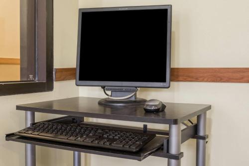 a computer monitor and a keyboard and mouse on a table at Super 8 by Wyndham Red Wing in Red Wing