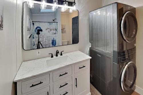 a bathroom with a sink and a refrigerator at Island Club #104 in Put-in-Bay