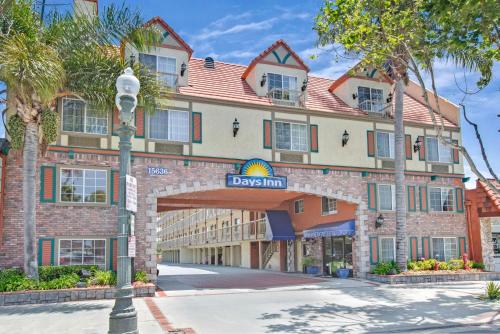 a building with a street sign in front of it at Days Inn by Wyndham Los Angeles LAX South Bay Beach City LA in Lawndale