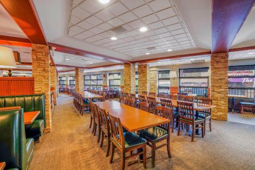 a dining room with wooden tables and chairs at Travelodge by Wyndham Niagara Falls At the Falls in Niagara Falls