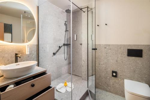 a bathroom with a sink and a shower at Best Western Plus Kurhotel an der Obermaintherme in Bad Staffelstein