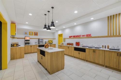 a large kitchen with wooden cabinets and counters at Hampton Inn Huntsville-Arsenal/South Parkway in Huntsville