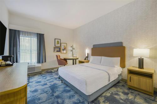 a hotel room with a bed and a desk at Hampton Inn Huntsville-Arsenal/South Parkway in Huntsville