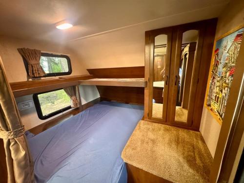 an inside view of an rv with a bed and windows at Glacier Park Hideaway in Columbia Falls