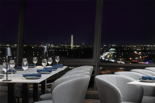 a restaurant with a view of a city at night at DoubleTree by Hilton Washington DC – Crystal City in Arlington