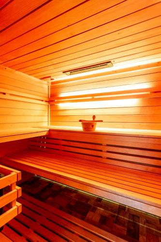 a wooden sauna with a pot on top of it at Guest House Hober in Prevalje