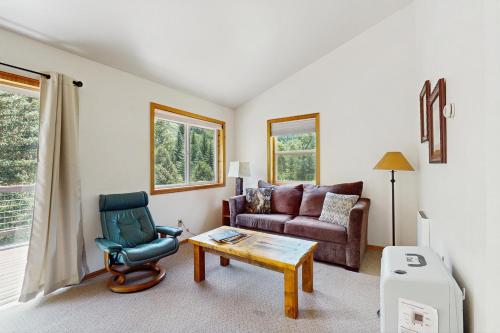 a living room with a couch and a chair at Elephant Mountain Cabin at Filoha Meadows in Redstone