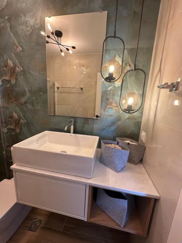 a bathroom with a sink and a mirror at Almyrolithos in Gythio